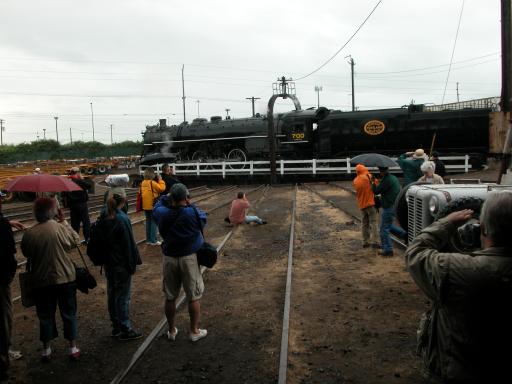 people in back door of roundhouse looking through rain at 700 on the turntable