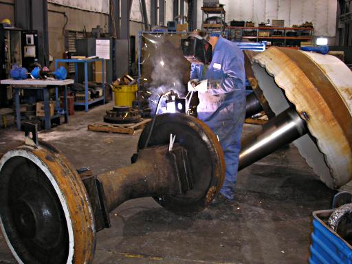 inside shop, welding lifting ears on wheels